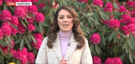 Laura Tobin presented in front of a huge bush