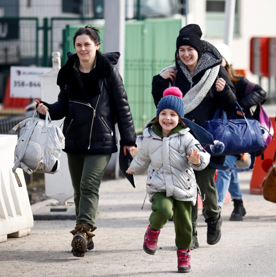 The beaming Ukrainian girl races to her dad at the end of a gruelling, 60-hour journey to safety