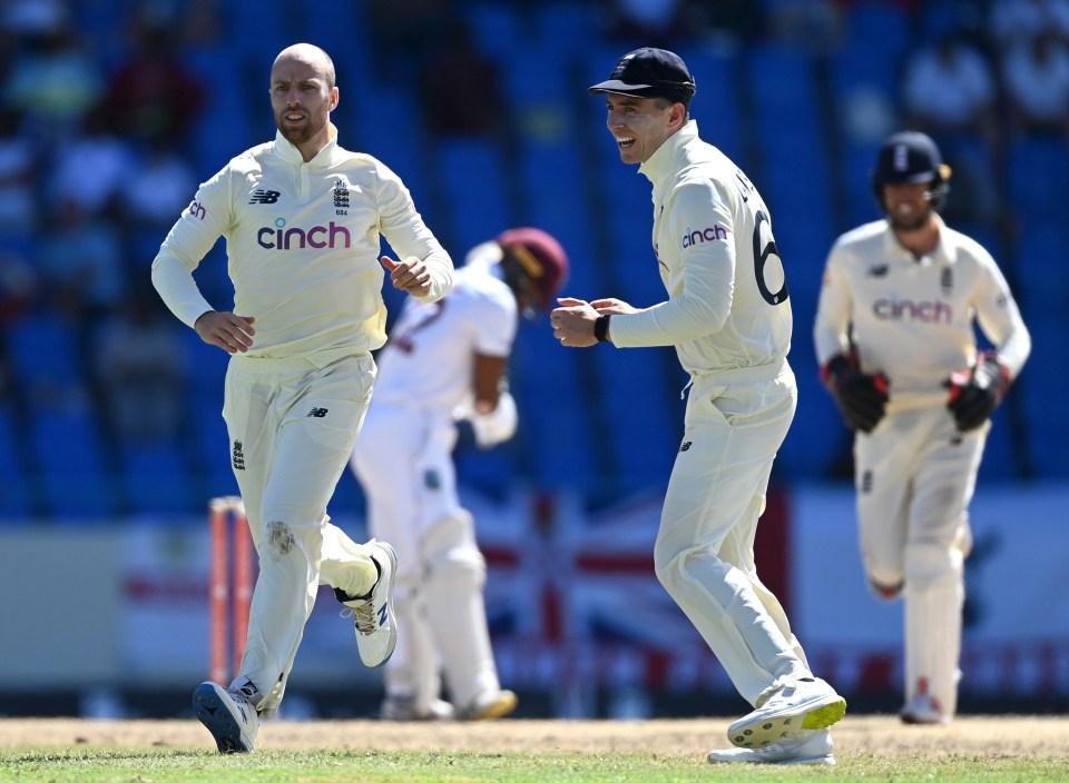 Jack Leach of England celebrates with Dan Lawrence after dismissing John Campbell of the West Indies during day five