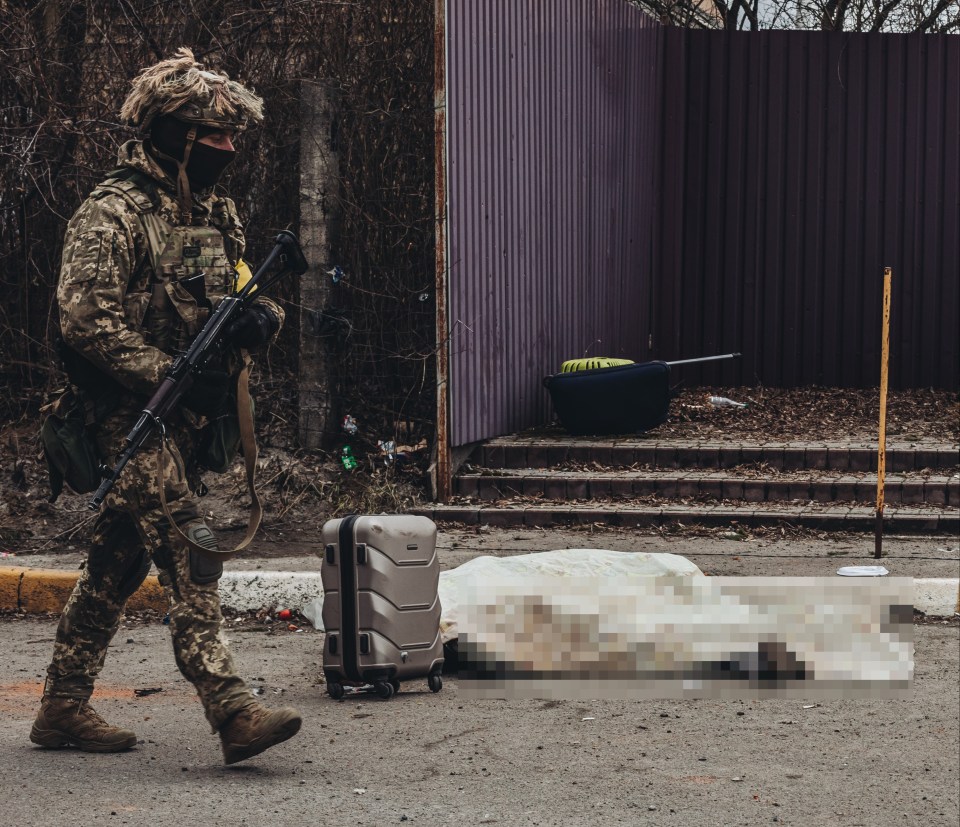 Suitcases and a pet carrier lay strewn near the victims' bodies after a bombardment by Russia