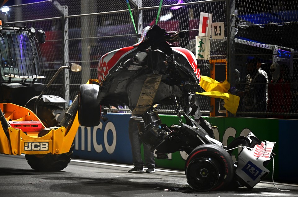 Schumacher's car broke in two as it was lifted off the track