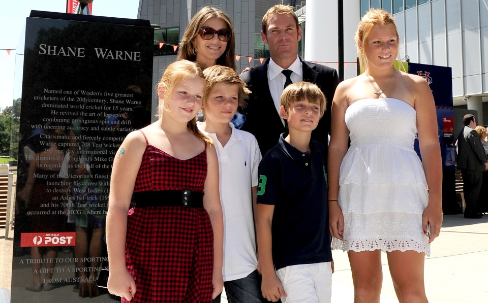 Shane Warne with his three children and then-girlfriend Liz Hurley with her son Damien in the black tee