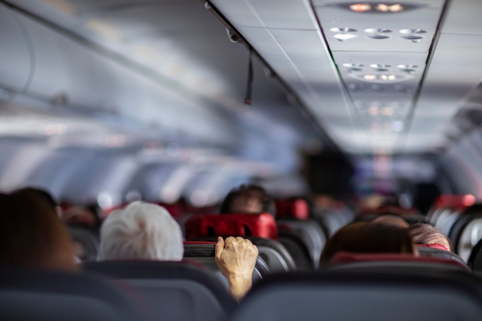 A passenger has split opinion after refusing to move from an empty row for other passengers