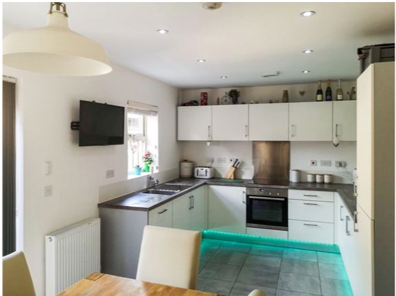 A plush kitchen with LED lighting offers a modern space