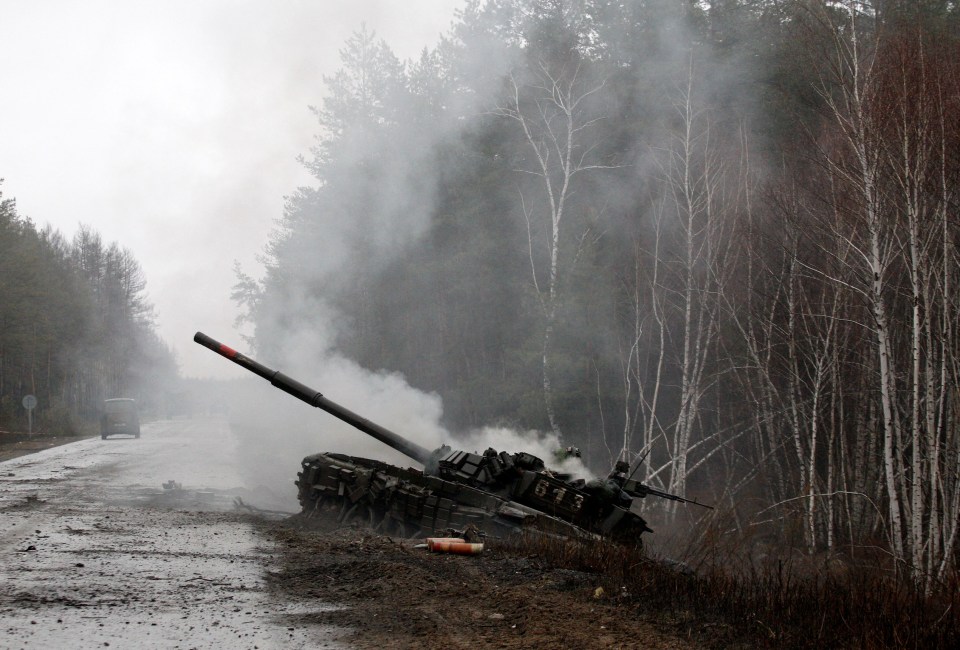 Smoke rises from a Russian tank destroyed by the Ukrainian forces