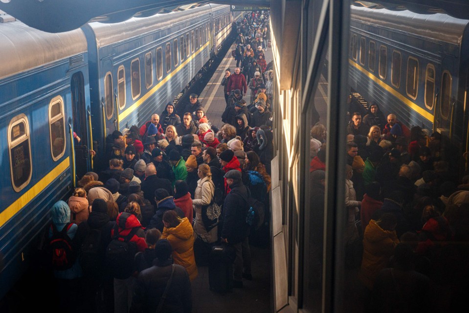 People board an evacuation train at Kyiv central train station