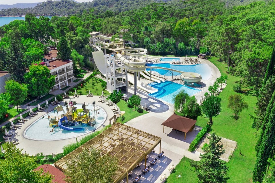 an aerial view of a water park with a boat shaped water slide