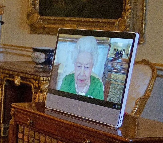 The Queen appears on a screen via videolink from Windsor Castle