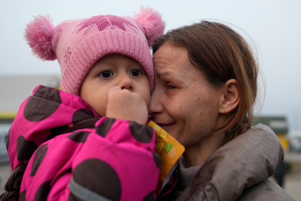 A women with a child who fled from the conflict in Ukraine after crossing the border in Medyka, Poland