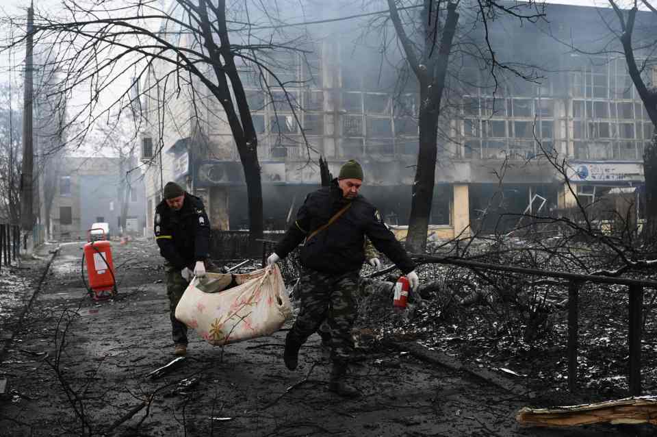 Police officers removing the body of a victim of a Russian airstrike on Kyiv's television tower