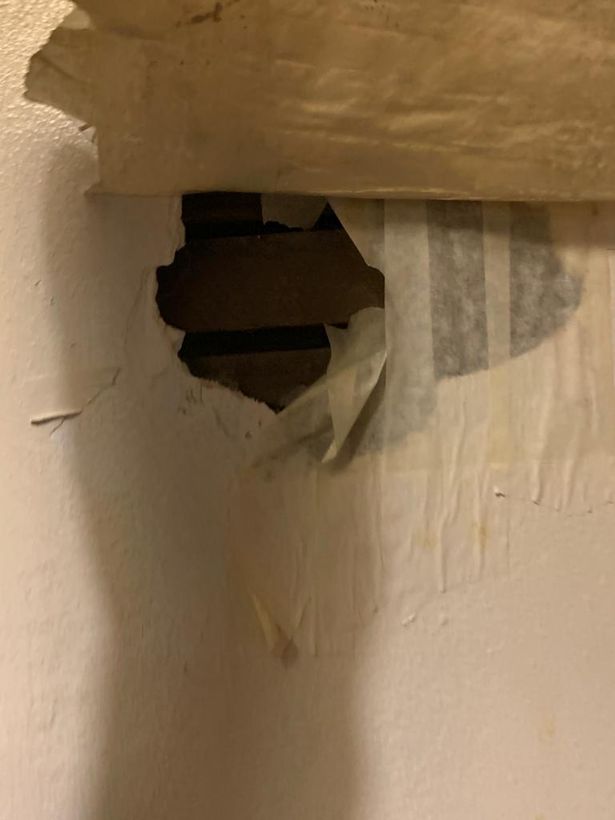 A large hole in the wall was horrifically 'patched up' with masking tape