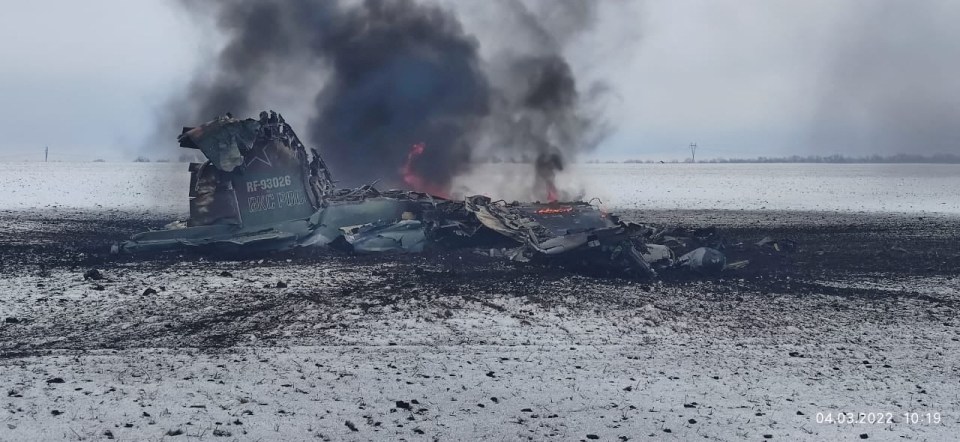 The burning wreckage of a Russian plane in a field outside Volnovakha in the Donetsk region