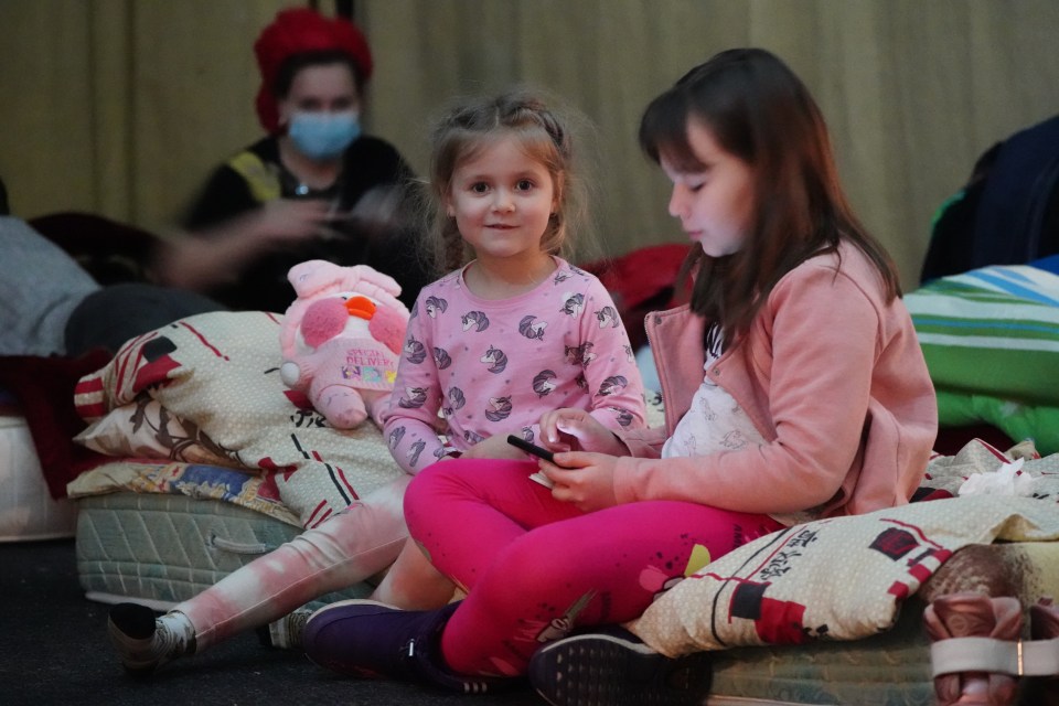 Katya, 4, and Arina, 9, take shelter in a theatre basement in Lviv, West Ukraine after fleeing the capital with their mum