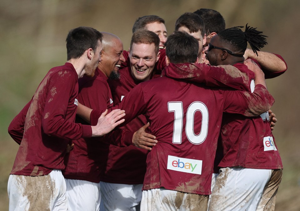 Team-mates celebrate with goal-scorer Roberto