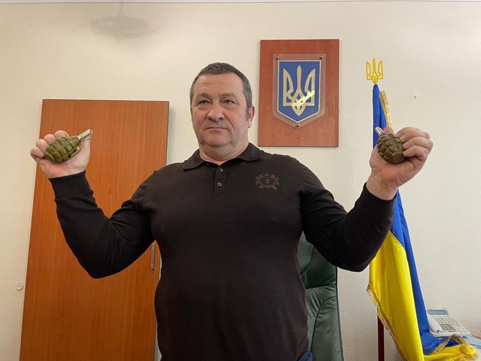 Mayor Gennady Brokovik held a grenade in each hand and vowed: 'We are ready to defend ourselves!'