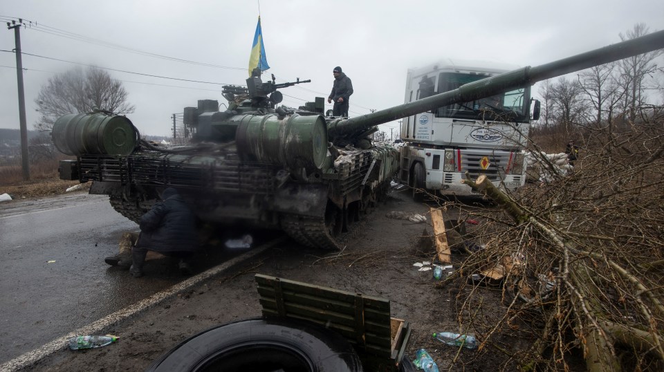 Ukrainian troops claim a captured Russian tank