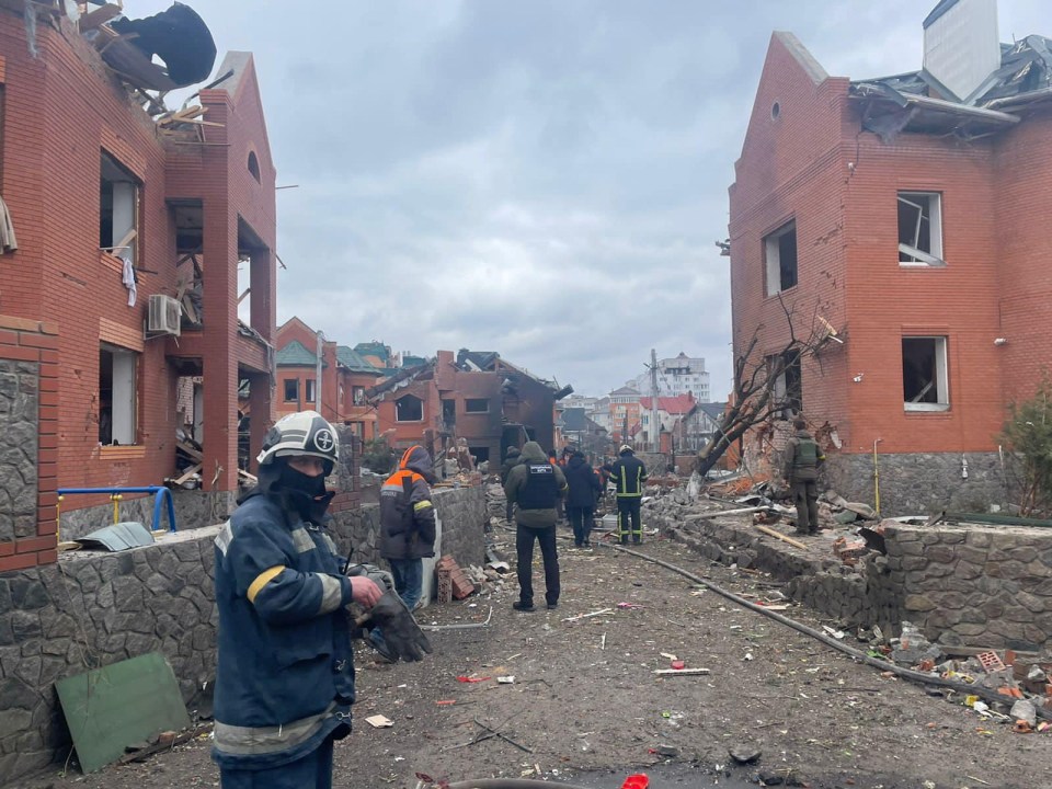 Emergency crews work at the scene where several houses have been damaged by an explosion, following an air strike in Bila Tserkva, Kyiv