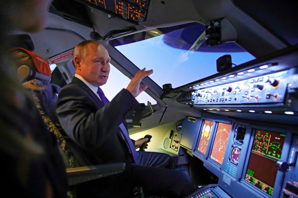 Vladimir Putin in the cockpit of a flight simulator today on a visit to Aeroflot Aviation School outside Moscow