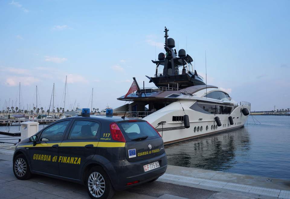 An Italian police car parked in front of Mordashov's Lady M docked at Imperia's harbor