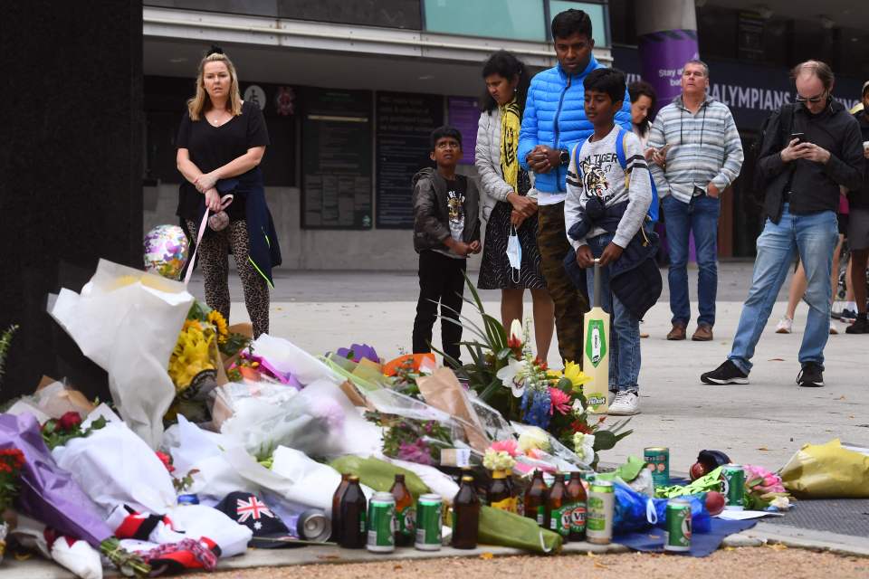 People pay their respects at a statue of cricket great Warne outside the Melbourne Cricket Ground