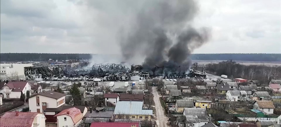 Smoke rises from the charred wreckage of homes in Mariupol