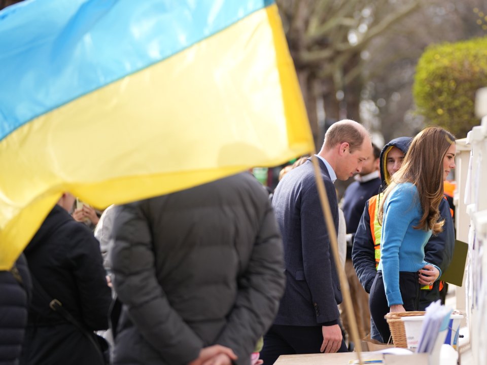 A Ukrainian flag waves as the royal couple arrive for their visit