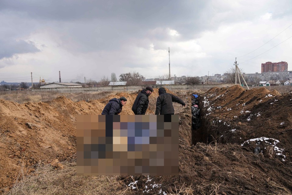 Dead bodies are laid in a newly-dug mass grave in Mariupol