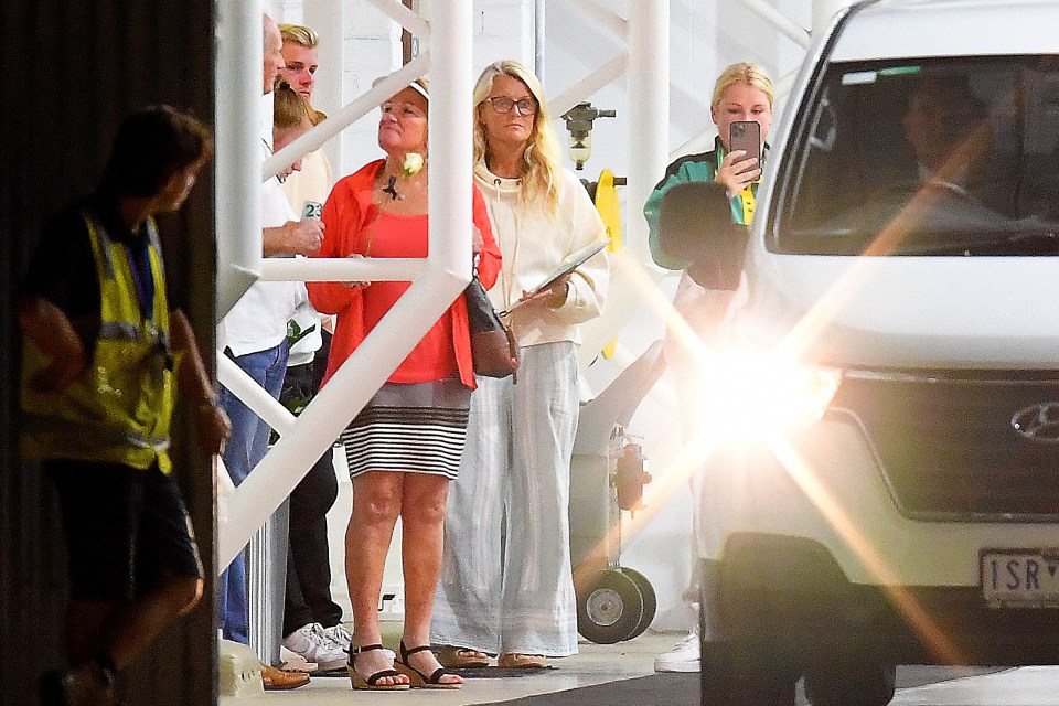 Shane's ex-wife Simone and family members wait at Melbourne airport to receive the icon's coffin