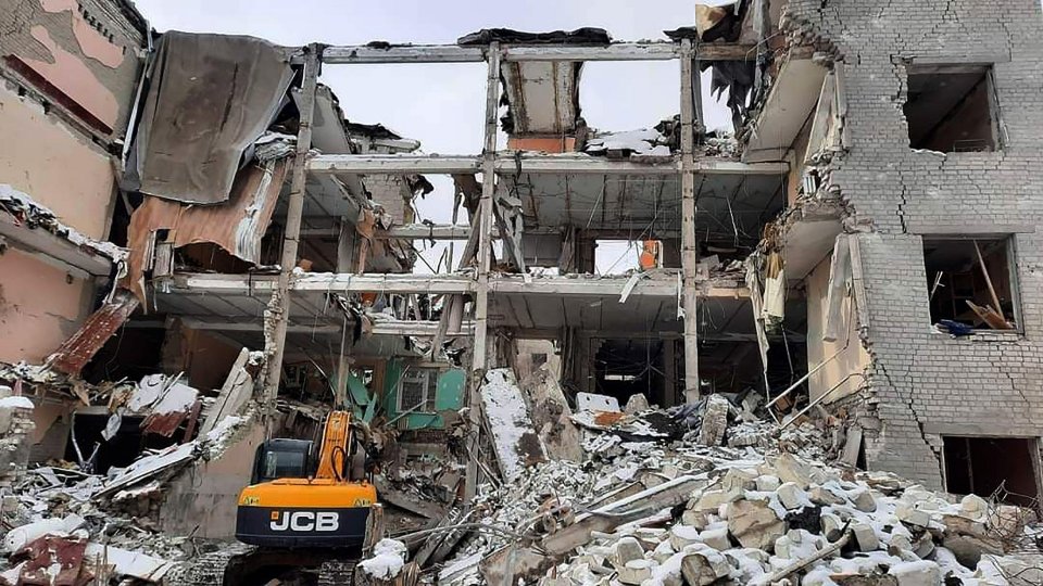 A Ukrainian rescue team inspects damaged residential buildings that were shelled by Russian forces in Kharkiv