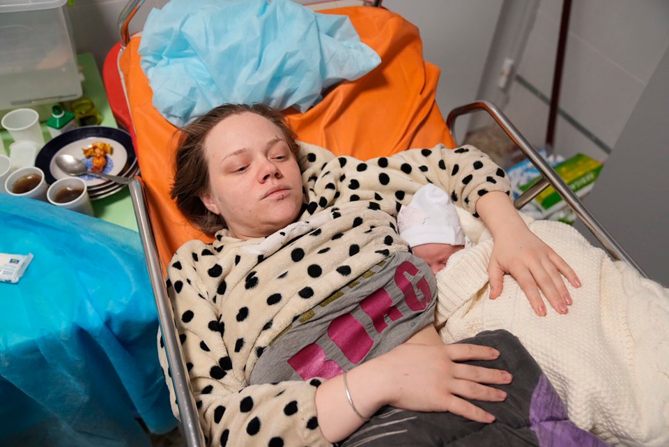 Mariana lays alongside her new baby after the ordeal in Mariupol