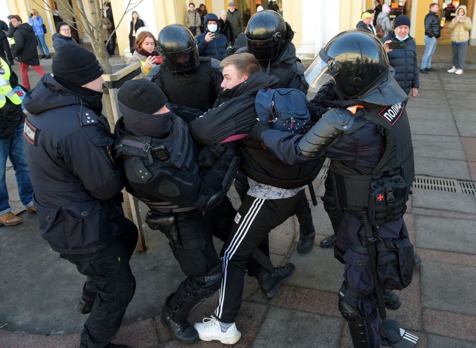 Officers detain a man during a protest against Russian military action in Ukraine, in central Saint Petersburg today