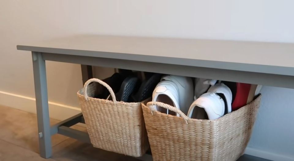 Simply using baskets to store shoes adds a decorative touch while keeping the area tidy