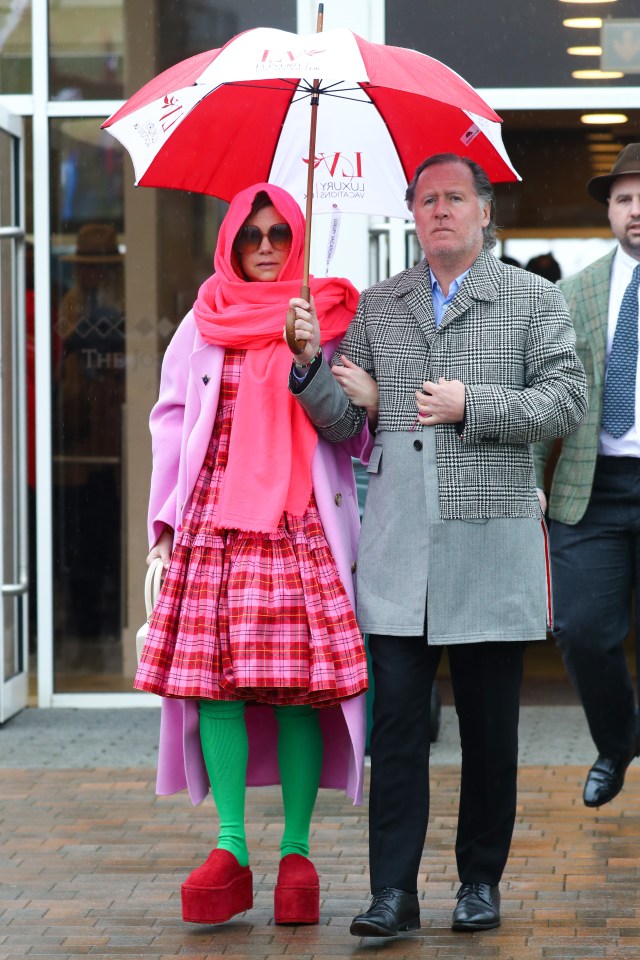 This reveller had her vibrant outfit protected from the elements by an umbrella