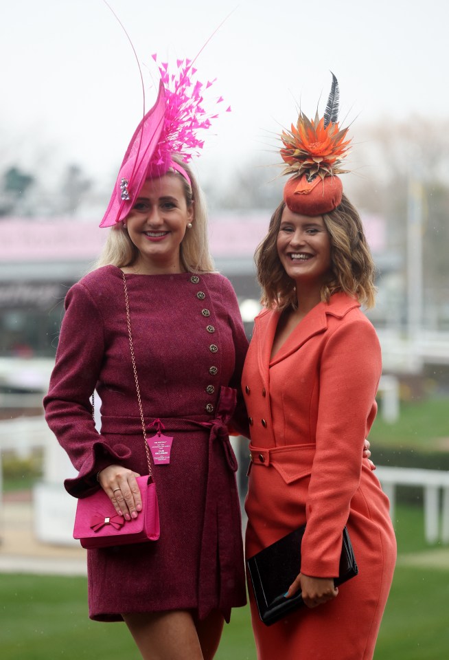 Smiling pals make a statement in bold dresses with matching headwear