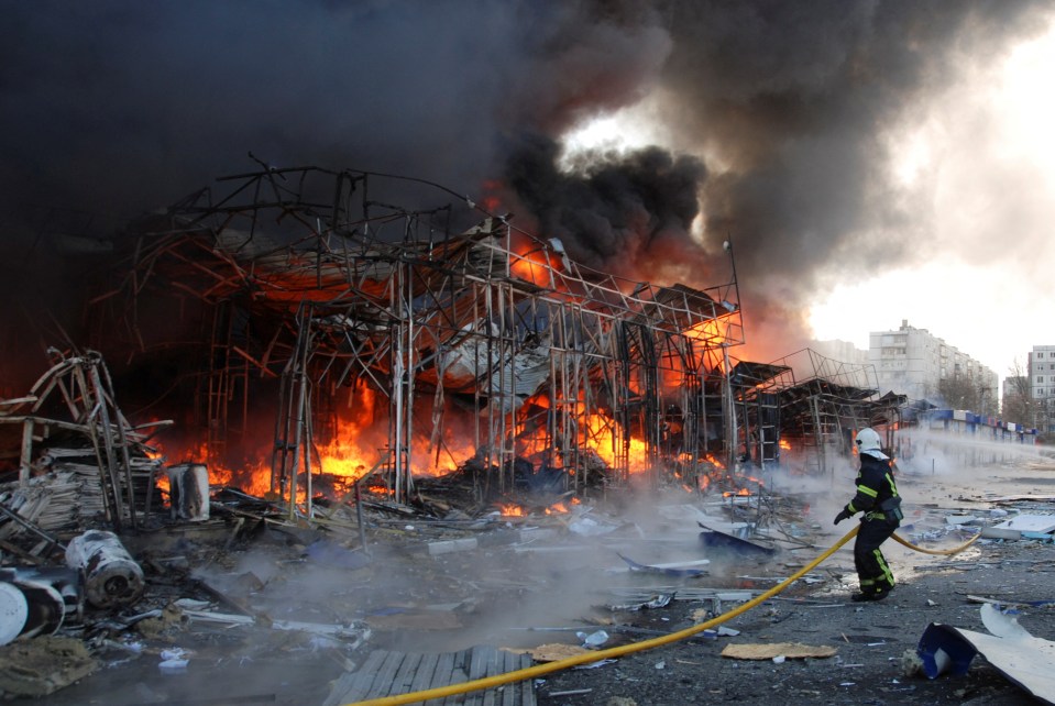 Firefighters tackle a blaze after a bombardment in eastern city Kharkiv