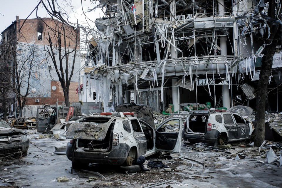 Damaged vehicles sit among debris and in Kharkiv city centre