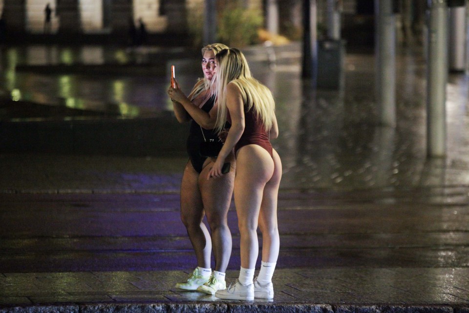 Two young women braved the wet weather in leotards