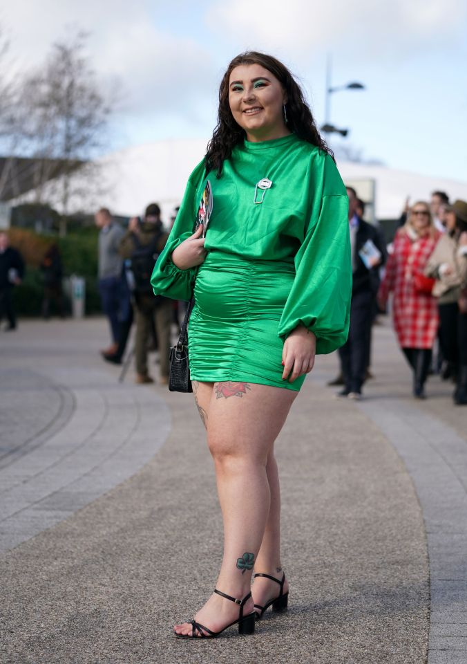 A woman with a shamrock tattoo on her ankle paid tribute to the Irish celebration wearing a green mini dress