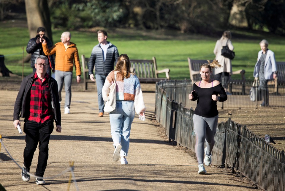 Members of the public relax in St James's Park, central London