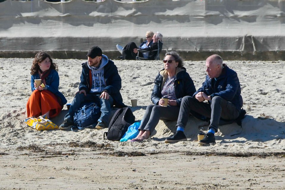 A family relaxes on the beach in Weymouth, Dorset