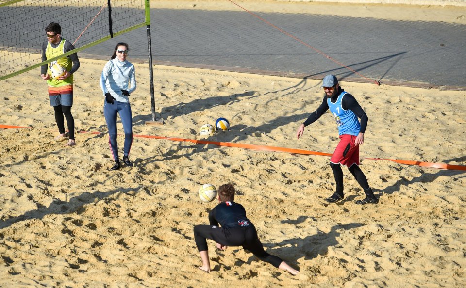 Beach volleyball players enjoy a beautiful sunny morning on Brighton seafront