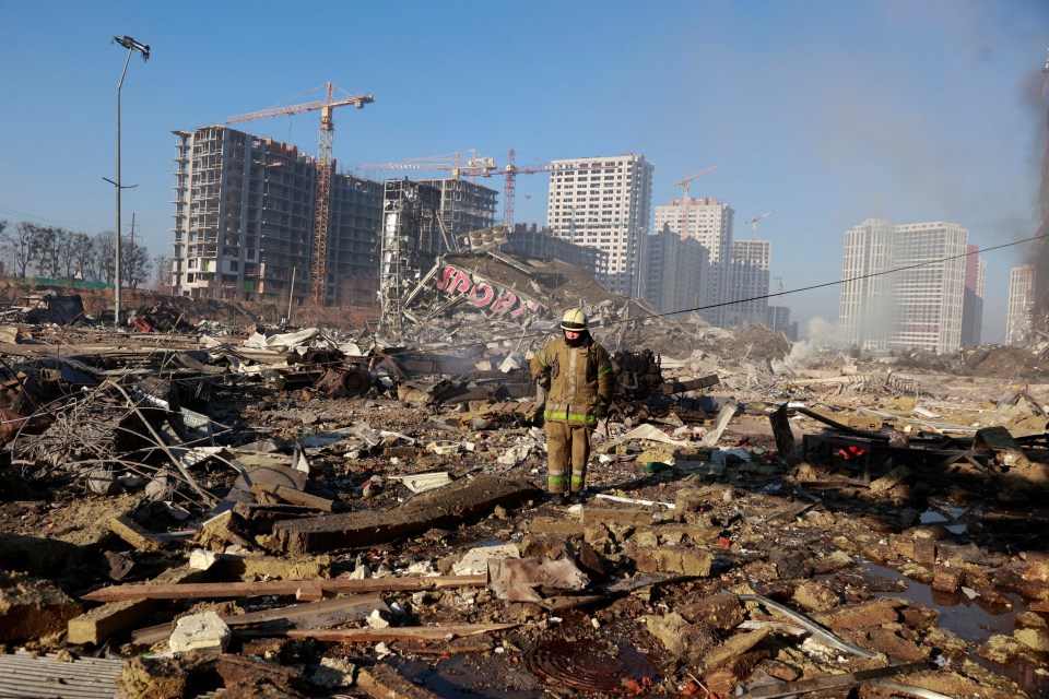 A rescue worker walks amongst the debris during a desperate search for survivors