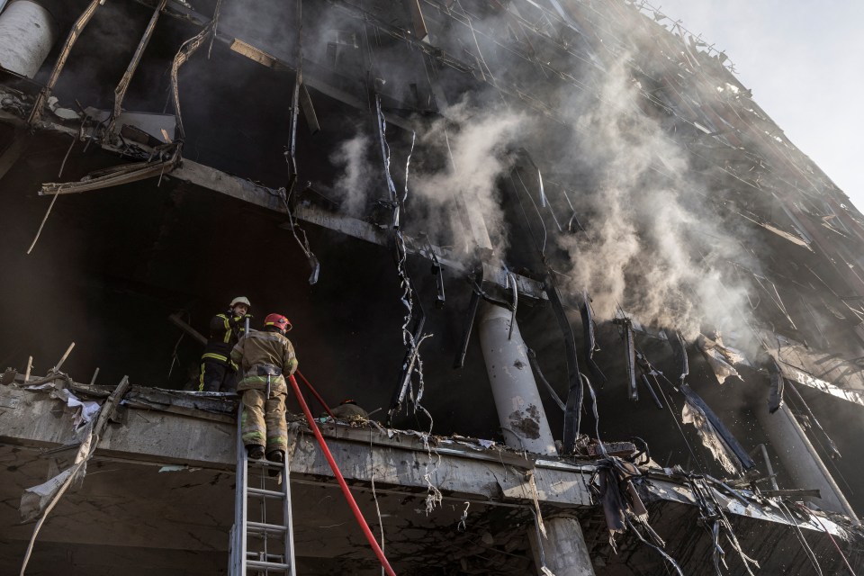 Rescuers piled into to the smouldering wreck of the building