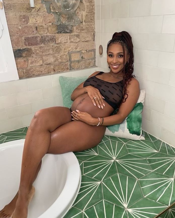 Alexandra Burke looked glowing as she cradled her baby bump in new snap