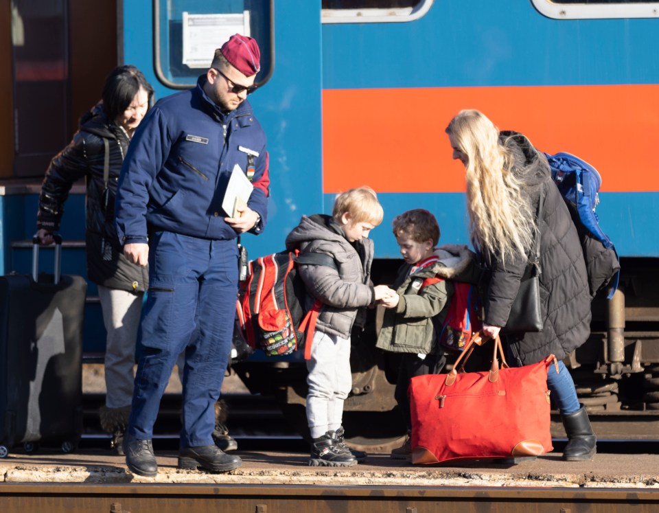 Refugee family stepping off train in Zahony