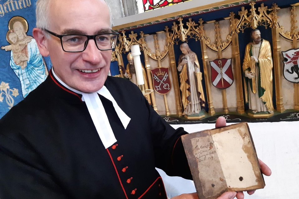 Britain's longest overdue library book has been returned after 313 years. Pictured Sheffield Cathedral’s Reverend Canon Keith Farrow