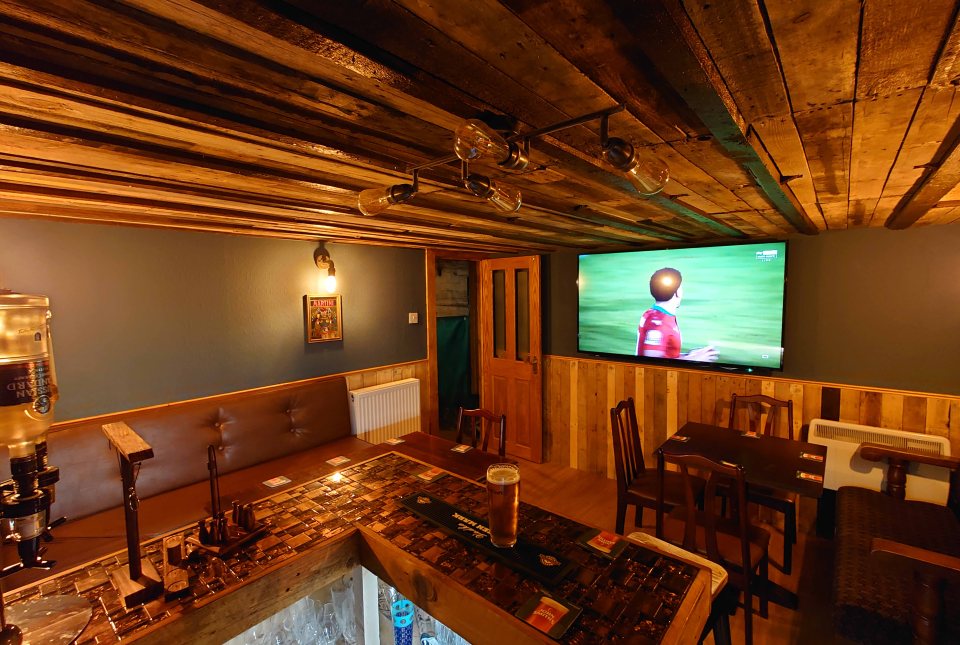 The bar is complete with a beer pump, lighting and a TV