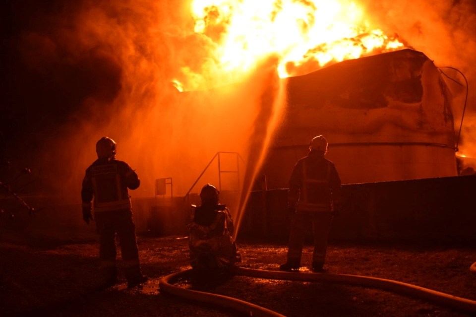 Firefighters tackle a shelled fuel depot in Ukraine