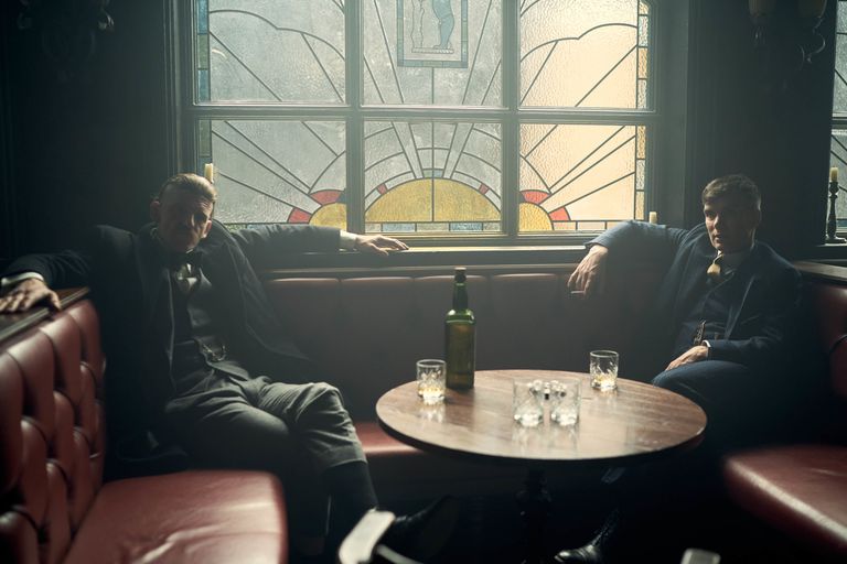 Tommy is seen sitting in a darkened pub alongside Arthur Shelby