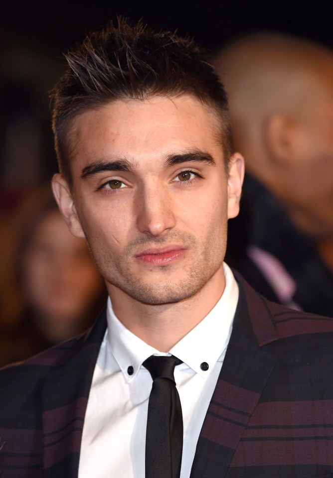 Tom Parker died at the age of 33. He rose to fame in the band The Wanted and is pictured in 2014